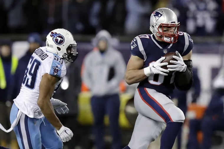 New England Patriots tight end Rob Gronkowski (87) catches a pass in front of Tennessee Titans linebacker Wesley Woodyard (59) during the second half of an NFL divisional playoff football game, Saturday, Jan. 13, 2018, in Foxborough, Mass.