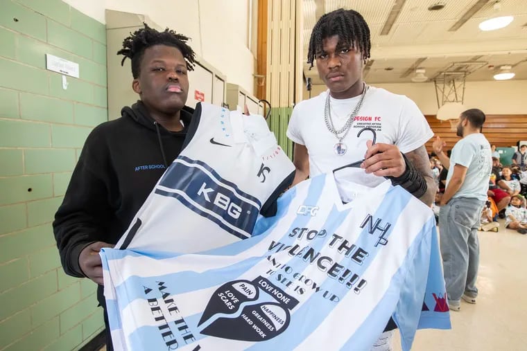Kevin Stanford (left) and Nyrell Hackett with the shirts they designed through Design FC.