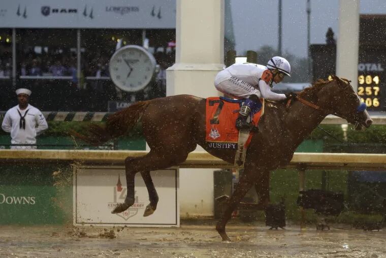 Mike Smith rides Justify to victory during the 144th running of the Kentucky Derby on Saturday.
