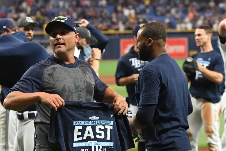 Manager Kevin Cash (left) and the Tampa Bay Rays are a low-budget success story.