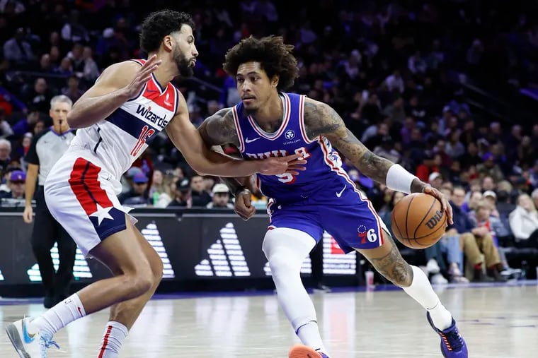 Sixers guard Kelly Oubre Jr., dribbles the basketball against Washington Wizards forward Anthony Gill on Monday, December 11, 2023 in Philadelphia.