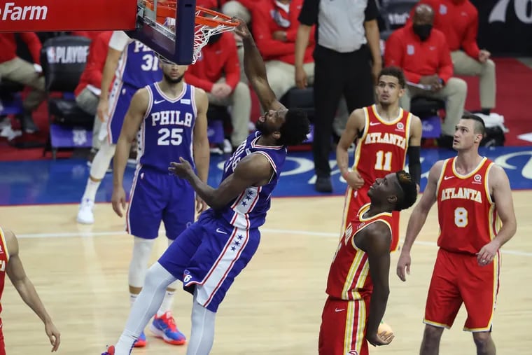 Joel Embiid dunks against the Hawks during the first half of Game 2.