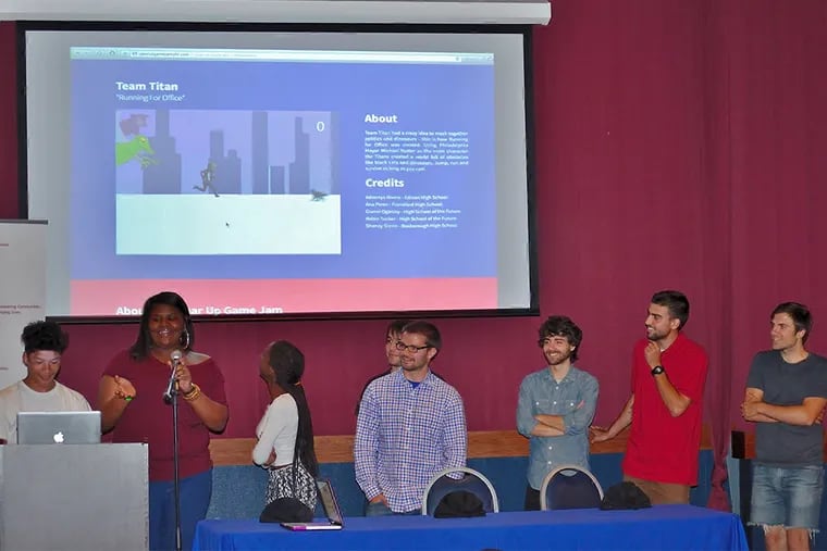 Adonnys Rivera (left) and Gianni Oglesby, of Team Titan, show off the video game they created, "Running for Office", which features Mayor Nutter running from a T-Rex and jumping over street cats.