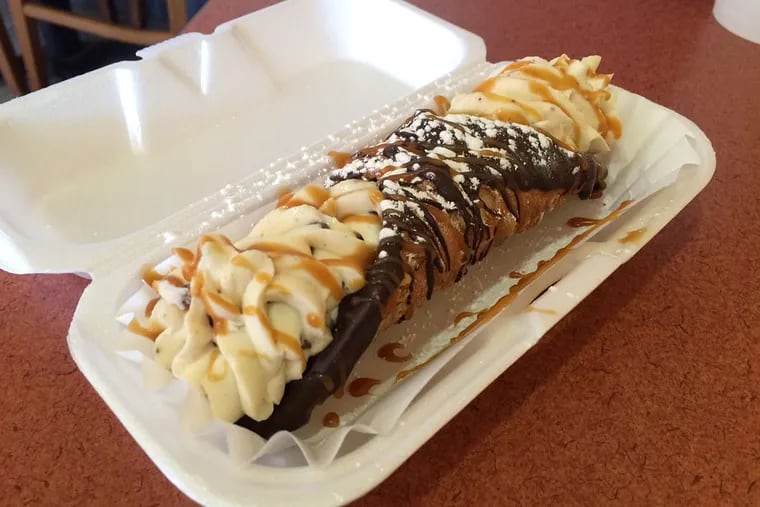 A chocolate-dipped, chocolate chip-filled cannoli from Cafe Crema in Philadelphia. ( Michael Klein / Philly.com )