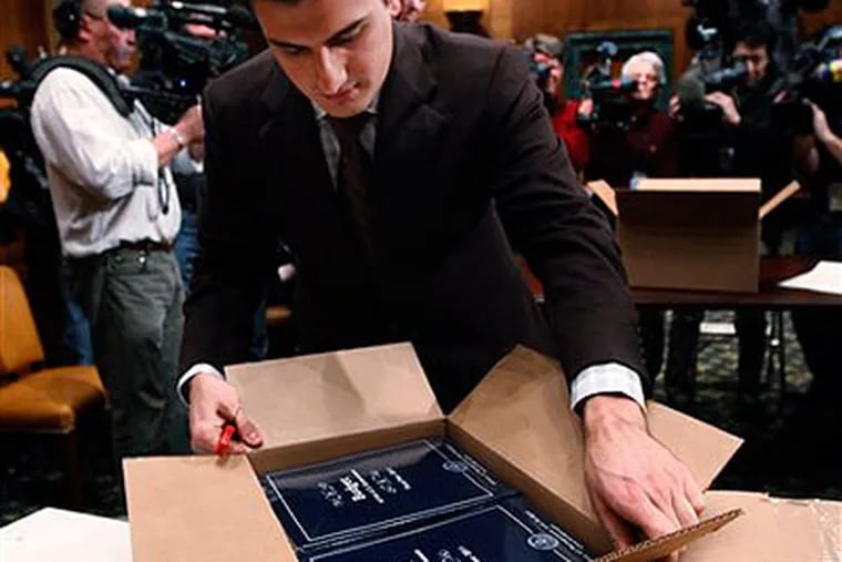 A Senate staffer unpacks copies of the Obama administration's proposed budget. (AP Photo / Manuel Balce Ceneta)