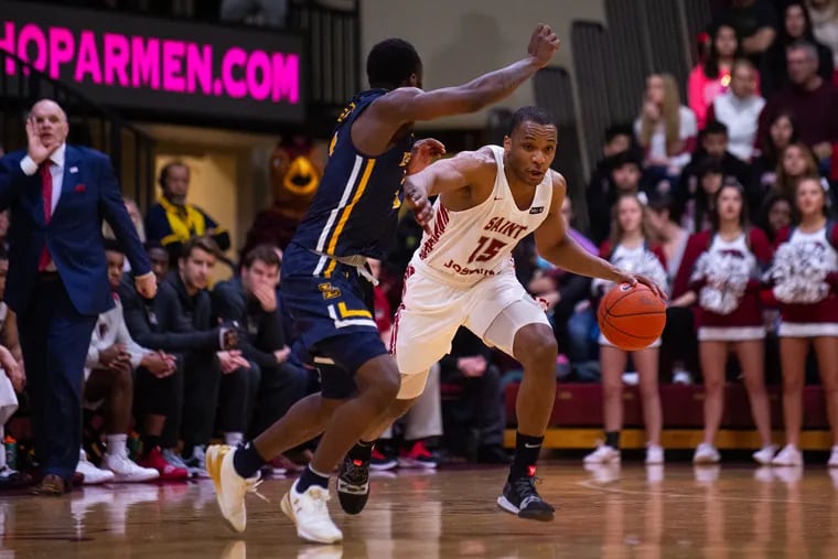 Chris Clover drives past La Salle's David Beatty on Saturday. Clover finished with 19 points to lead the Hawks.