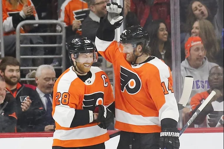 Flyers center Claude Giroux (left) celebrates his second-period power play goal with Sean Couturier against the New York Rangers on Saturday.