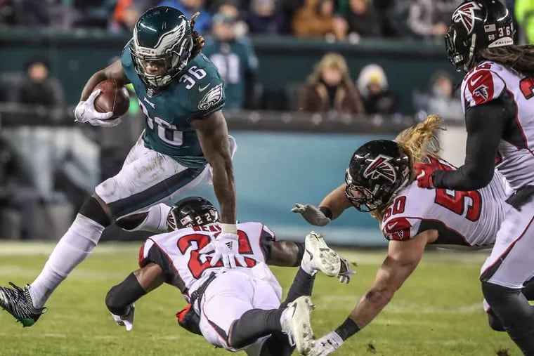 Eagle running back Jay Ajayi, #36, left, turns the corner on Atlanta’s #22, Keanu Neal, center, in the fourth quarter of the win over the Falcons on Saturday. The NFL Divisional Playoffs, Eagles versus the Falcons at Lincoln Financial Field on January 13, 2018.