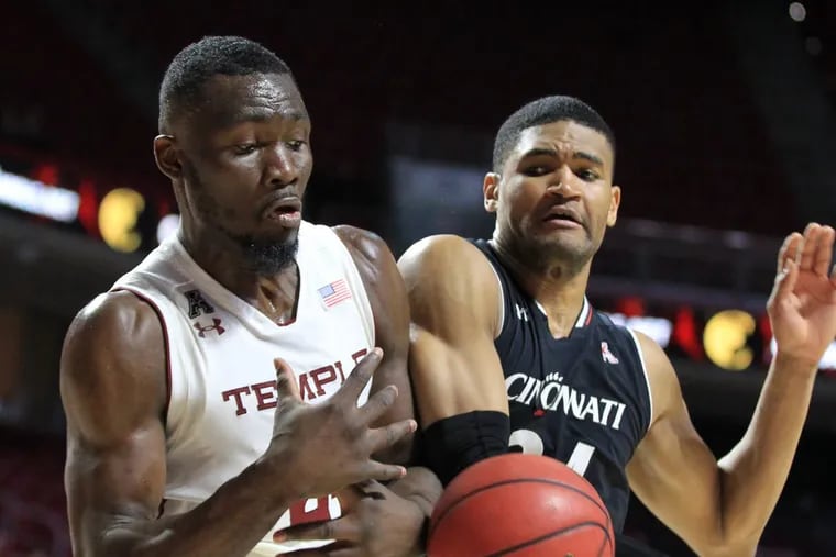 Ernest Aflakpui, left, of Temple and Kyle Washington of Cincinnati battle for control of a rebound during the game at the Liacouras Center at Temple University on Jan 4, 2018. CHARLES FOX / Staff Photographer