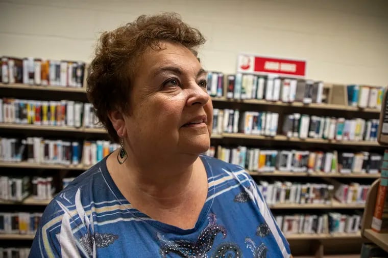 Norene Ritter, of Vineland, president of Friends of the Vineland Public Library, in front of the audio books section in the Vineland Public Library.