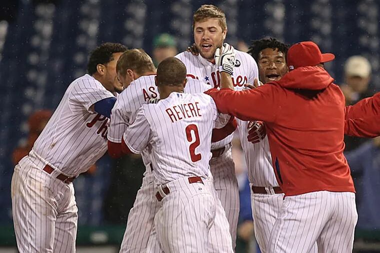 Darin Ruf gets mobbed by teammates at first base after hitting a walk-off single to beat the Reds. (Steven M. Falk/Staff Photographer)