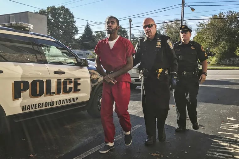 Derrick Rollins, accused of killing 29-year-old John Le in Haverford Township in July, is led into his preliminary hearing in Delaware County on Oct. 26, 2017