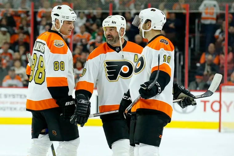Former Flyers Eric Lindros, John LeClair and Mikael Renberg (left to right), known as the team's Legion of Doom, on the ice during a 2017 alumni game against the Pittsburgh Penguins. Lindros and LeClair will play in Monday's "Orange & Black" alumni game at the Wells Fargo Center.
