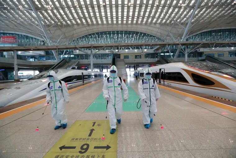 In this photo released by Xinhua News Agency, firefighters conduct disinfection on the platform of Wuhan Railway Station in Wuhan, central China's Hubei Province, March 24, 2020. Chinese authorities said Tuesday they will end a two-month lockdown of most of coronavirus-hit Hubei province at midnight, though the provincial capital will remain closed til April 8, as domestic cases of the virus continue to subside.