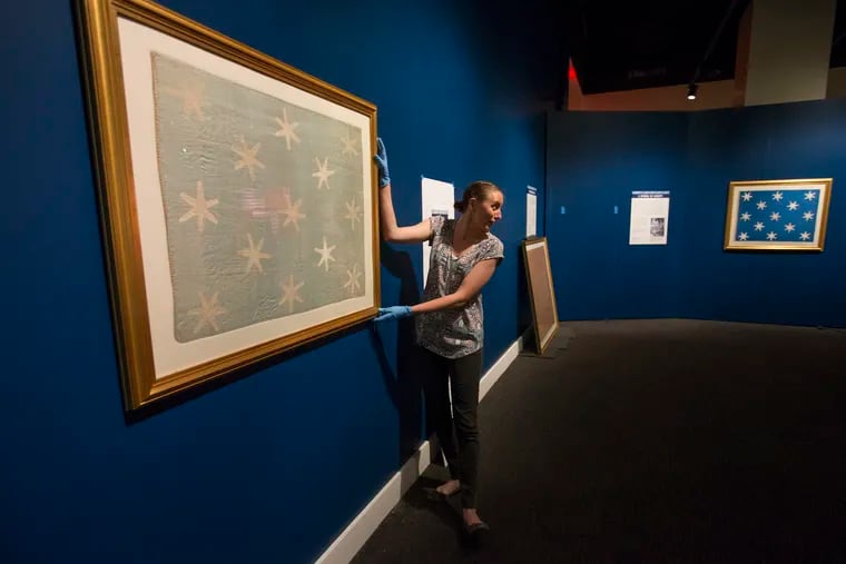 The Museum of the American Revolution is pulling out of its archives General Washington's personal flag, which marked his presence on the battlefield. It's incredibly fragile, which is why they say they can't have it on regular display. It will be the first time the museum will display it, and the first time it will be on display since the 1990s. Michelle Moskal, Collections Manager/Registrar adjusts the flag in the exhibition area on June 13, 2018. In the background is the version Astronaut John Glenn took into space. The original flag faded while hung at the Washington Memorial Chapel at Valley Forge. CHARLES FOX / Staff Photographer