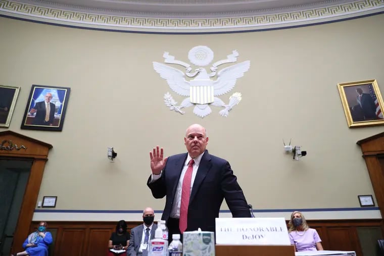 U.S. Postmaster General Louis DeJoy is sworn in to testify before a House Oversight and Reform Committee hearing on slowdowns at the Postal Service ahead of the November elections.