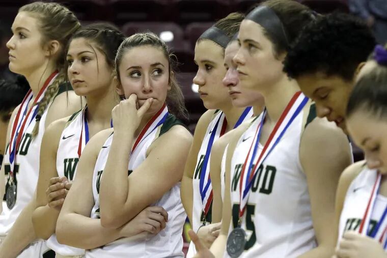 The Archbishop Wood girls basketball team stands quietly after receiving their runner up medals after the Archbishop Wood vs Mars HS Girls Class 5A PIAA State Championship basketball game at the Giant Center in Hershey, Pa. on March 28, 2018. Archbishop Wood loses to Mars 36-33. ELIZABETH ROBERTSON / Staff Photographer