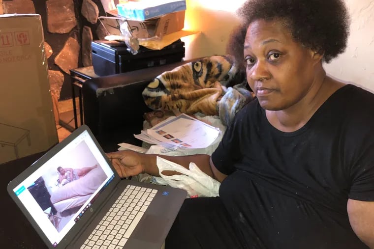 In her Southwest Philadelphia home, Angela Jones looks at videos of her daughter, Asia, who went to a store March 7 and never returned.