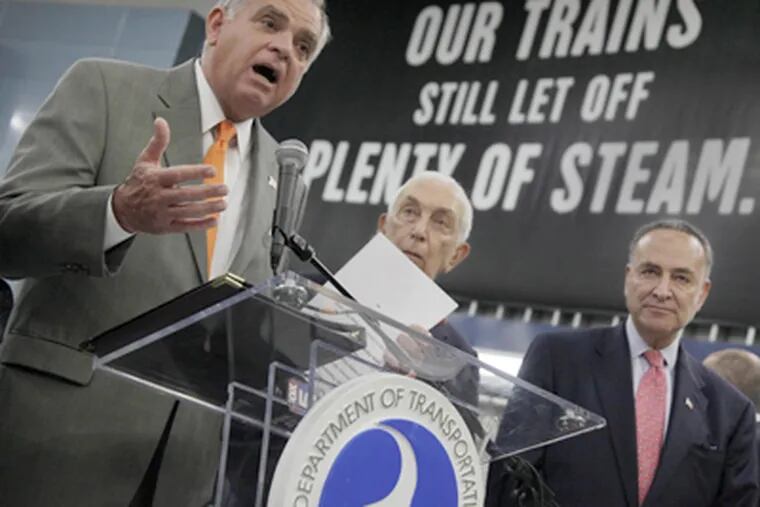 In N.Y.'s Pennsylvania Station, U.S. Transportation Secretary Ray LaHood (left) is joined by U.S. Sen. Frank Lautenberg (D., N.J.) (center) and U.S. Sen. Charles Schumer (D., N.Y.) in announcing the rail funding. (Richard Drew / Associated Press)