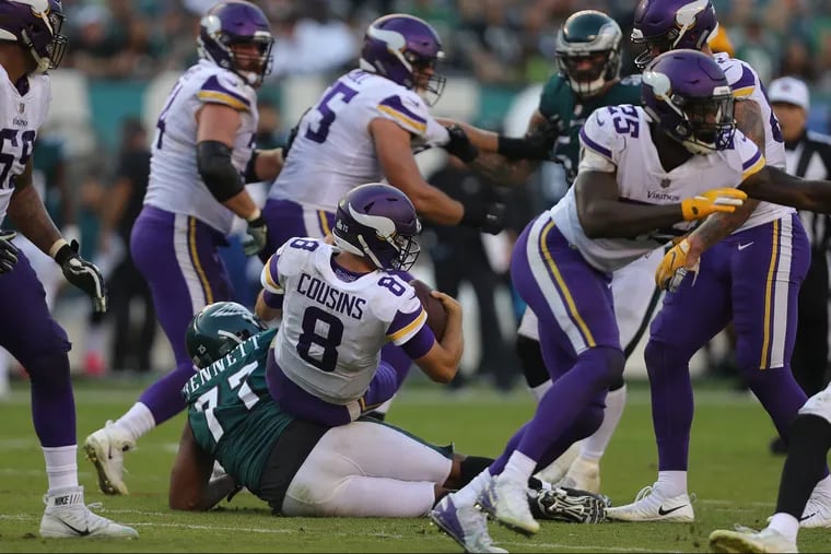 Eagles Michael Bennett, left, was called from a personal foul after sacking the Vikings Kirk Cousins in the 2nd quarter as the Philadelphia Eagles play the Minnesota Vikings in Philadelphia, PA on October 7, 2018. DAVID MAIALETTI / Staff Photographer