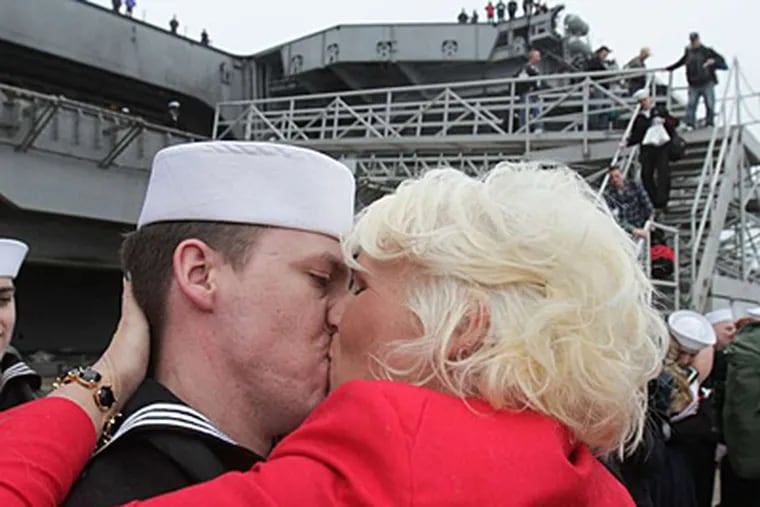 At Naval Station Norfolk in Virginia, Gina Shelton kisses her husband, Petty Officer 2d Class Matthew Shelton, after the Enterprise returned home. STEVE EARLEY / Virginian Pilot