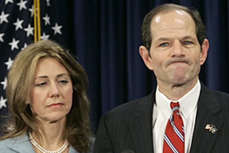 New York State Gov. Eliot Spitzer is joined by his wife Silda as he makes a statement to reporters during Monday's news conference.
