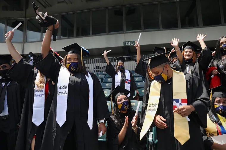Graduates cheer at the end of La Salle University's Class of 2021 commencement at Lincoln Financial Field in South Philadelphia on Saturday, May 15, 2021. Approximately 1,500 students graduated from the university Saturday in the first such ceremony to be held in the stadium.