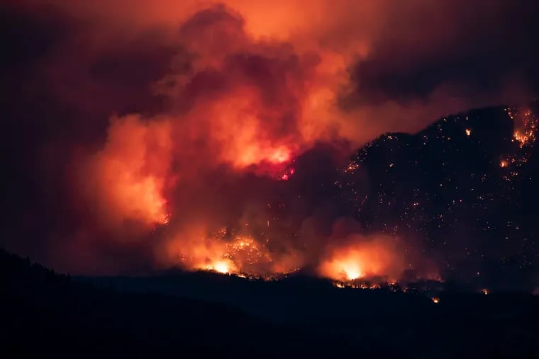 A wildfire burns on the side of a mountain in Lytton, British Columbia, on July 1. About 1,000 people were evacuated from the town. Smoke from the Pacific Northwest fires is causing a milky haze over Philly.