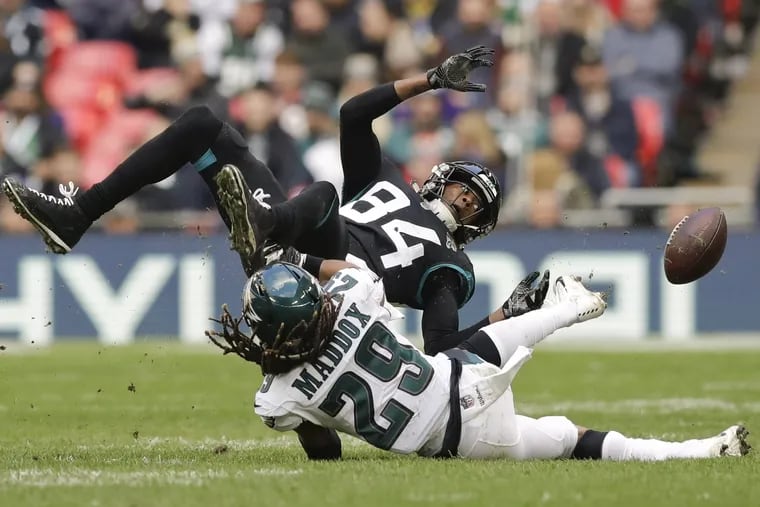 Jacksonville Jaguars wide receiver Keelan Cole (84) is tackled by Philadelphia Eagles free safety Avonte Maddox (29) during the first half of an NFL football game at Wembley stadium in London, Sunday, Oct. 28, 2018. (AP Photo/Matt Dunham)