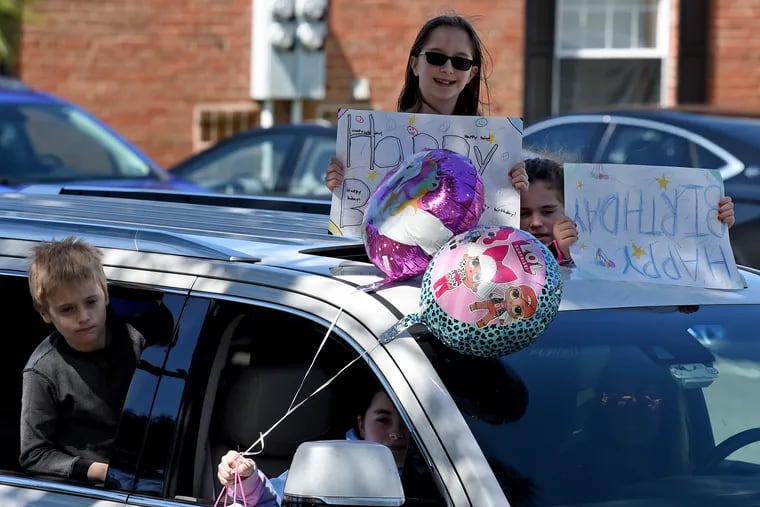 In this file photo, balloons and signs help a family make a child's birthday festive during the coronavirus quarantine. In New Jersey, there was confusion about whether such events were permitted. Col. Patrick Callahan of the New Jersey State Police clarified Monday that the events were permitted as long as no large crowds gathered.