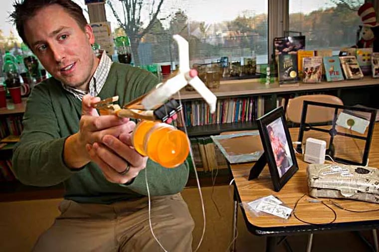 Michael Carroll is an 4th grade elementary school teacher at Overlook Elementary School in Abington, PA. Photograph of Carroll with inventions created to get students engaged in class. This one is called the Claw Gun. Photograph from Thursday morning November 21, 2013. ( ALEJANDRO A. ALVAREZ / STAFF PHOTOGRAPHER )