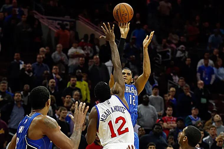 The Magic's Tobias Harris shoots the game-winning shot over the Sixers' Luc Mbah a Moute. (Yong Kim/Staff Photographer)