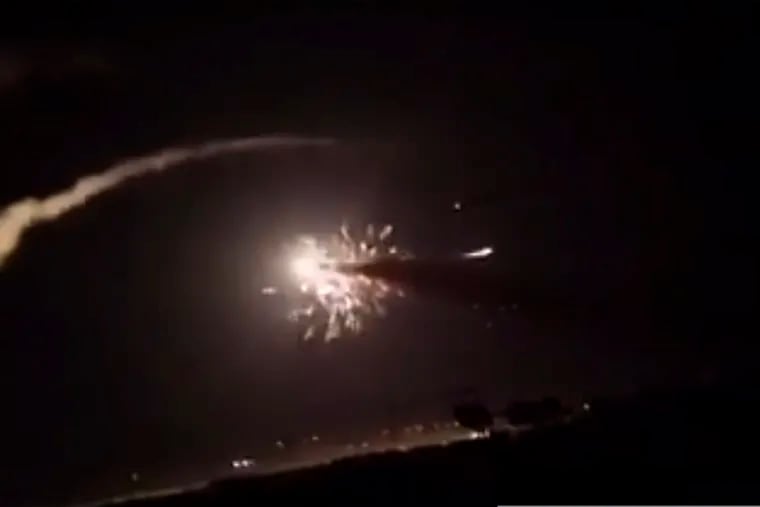 This frame grab from a video provided by the Syrian official news agency SANA shows missiles flying into the sky near Damascus, Syria, Tuesday, Dec. 25, 2018. Israeli warplanes flying over Lebanon fired missiles toward areas near the Syrian capital of Damascus late Tuesday, hitting an arms depot and wounding three soldiers, Syrian state media reported, saying that most of the missiles were shot down by air defense units. (SANA via AP)