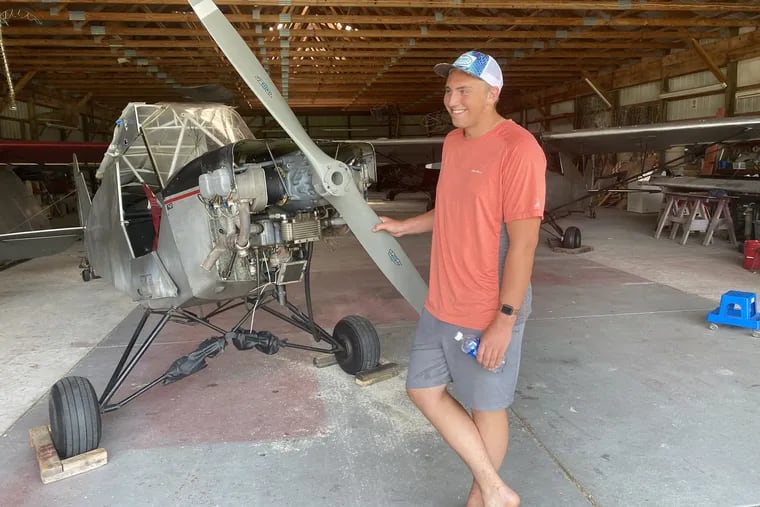 Pilot Landon Lucas, 18, next to the 1946 J-3 aircraft he successfully landed on the Ocean City- Somers Point bridge on Monday. The plane suffered "not even a scratch," he said.