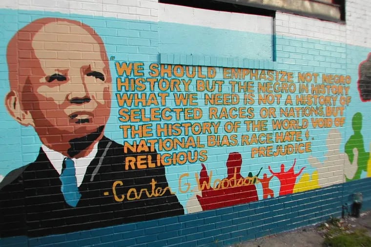 A mural in Washington, D.C., pays tribute to historian Carter G. Woodson, who in 1926 created what became Black History Month.