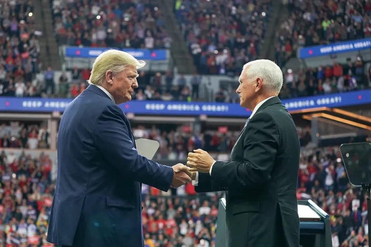 President Donald Trump (left) with Vice President Mike Pence at a campaign rally in Minneapolis on Oct. 10.