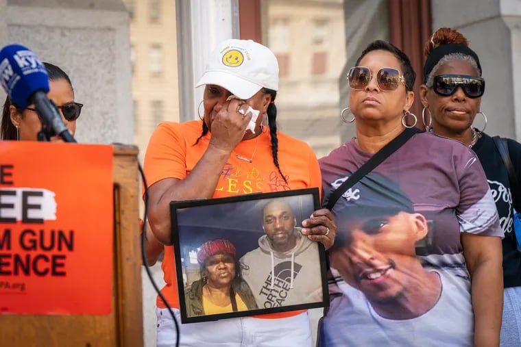 Angela Gibson, (center), whose son Rahshine James McClary was shot and killed, with Crystal Arthur, (right), whose son Kristian Hamilton Arthur was shot and killed, at a gathering of people who have been impacted by gun violence, at City Hall, in Philadelphia, Sept. 12, 2023.