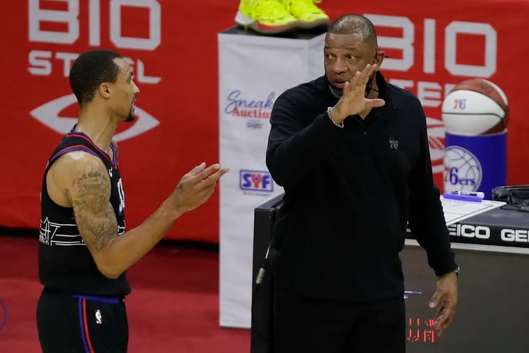 Sixers coach Doc Rivers talking to guard George Hill during a fourth-quarter break against the Detroit Pistons on Saturday.