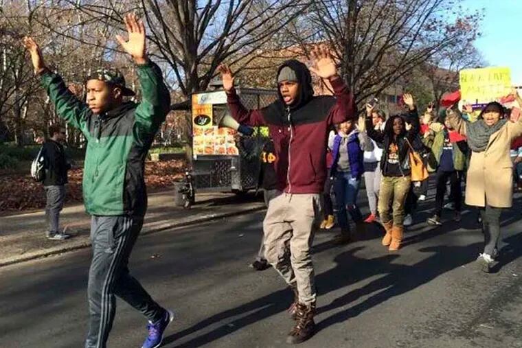 Michael Larmond,23,  leads protesters down 13th Street to the Temple Student Center for next “die-in” demonstration. Sofiya Ballin/Staff