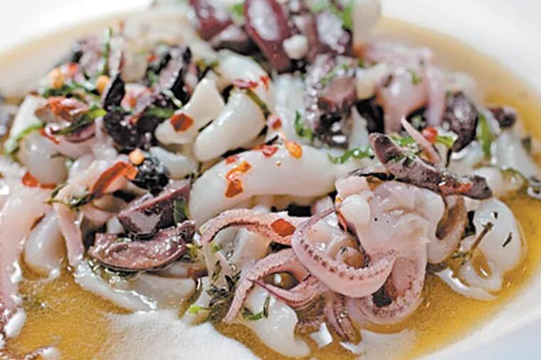 Sauteed calamari, left, with olive oil, lemon, white wine, black olives. (DAVID M WARREN / Staff Photographer)