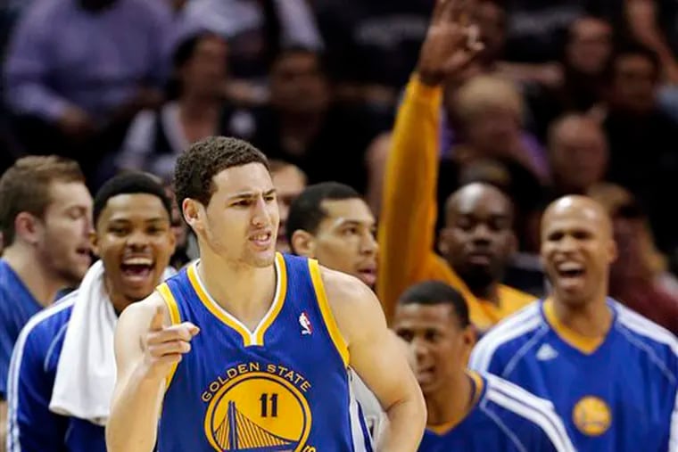 Golden State Warriors' Klay Thompson (11) celebrates a basket against the San Antonio Spurs during the first half in Game 2 of their Western Conference semifinal NBA basketball playoff series, Wednesday, May 8, 2013, in San Antonio. (AP Photo/Eric Gay)