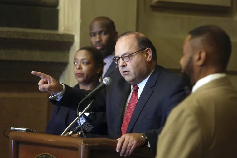 Philadelphia City Councilmember Allan Domb, center, addresses a gathering at City Hall in October 2017.