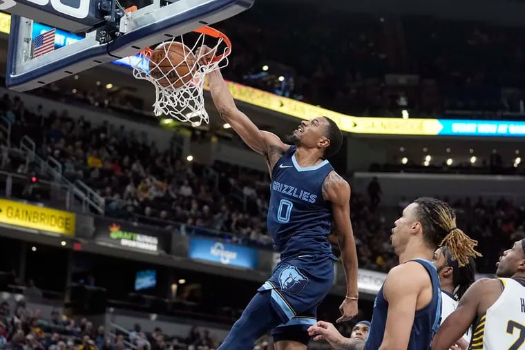 Memphis Grizzlies' De'Anthony Melton (0) dunks during the second half of an NBA basketball game against the Indiana Pacers, Tuesday, March 15, 2022, in Indianapolis.