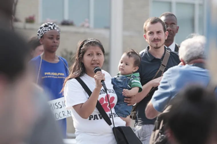 Angelica Victoriano addresses the "people's School Reform Commission" at a protest at School District headquarters. (Ed Hille / Staff Photographer)
