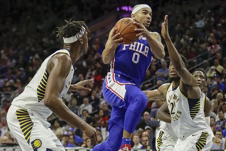 Sixers guard Jerryd Bayless drives to the basket against Indiana Pacers center Myles Turner (left) and Pacers forward Thaddeus Young.