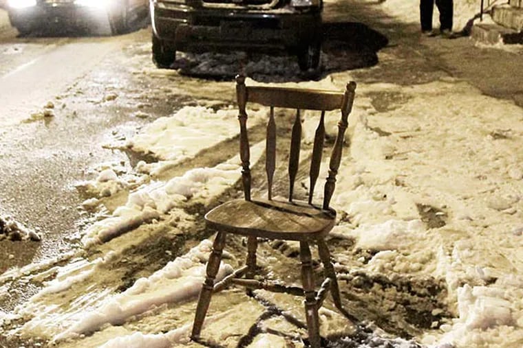 A chair at Fifth and Ritner streets is used to save a shoveled-out spot. (Elizabeth Robertson/Staff)