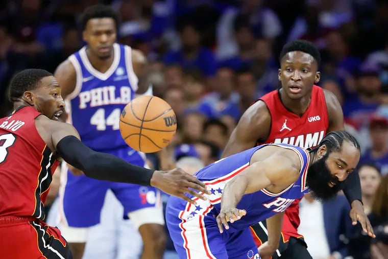 Sixers guard James Harden loses the basketball to Miami Heat center Bam Adebayo with teammate guard Victor Oladipo during the third quarter in the second-round Eastern Conference playoffs on Thursday, May 12, 2022 in Philadelphia.