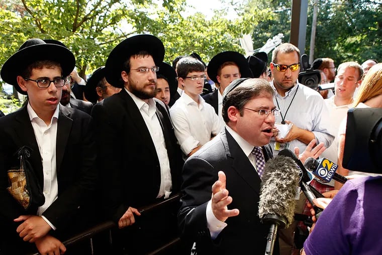 Yisroel Serebrowski, rabbi of Torah Links in Cherry Hill, talks to reporters after a news conference in front of the Lakewood Town Hall.
