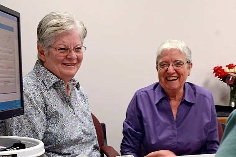 Peg Welch (left) and Delma Welch of York apply for a marriage license in Norristown last week. TOM GRALISH / Staff Photographer
