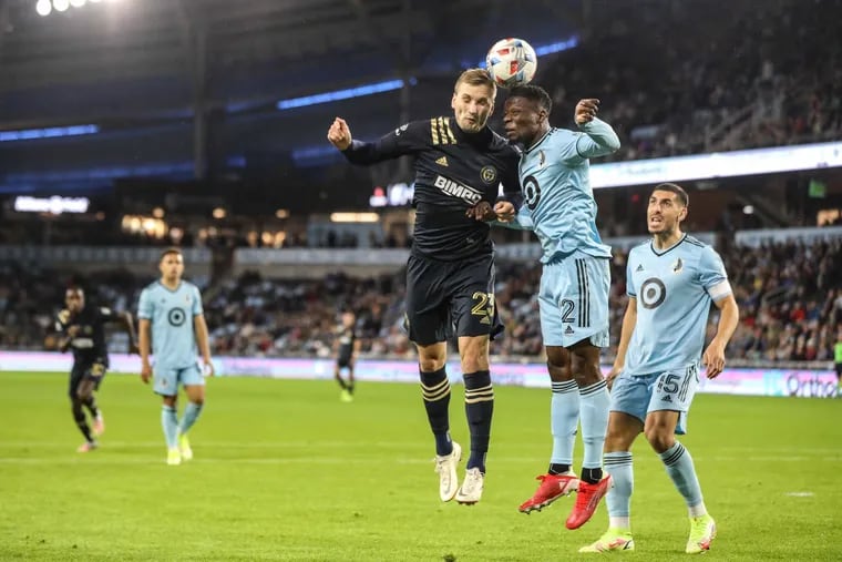 Kacper Przybylko (23) goes up for a header against Bakaye Dibassy during the Union's loss to Minnesota United at Allianz Field.